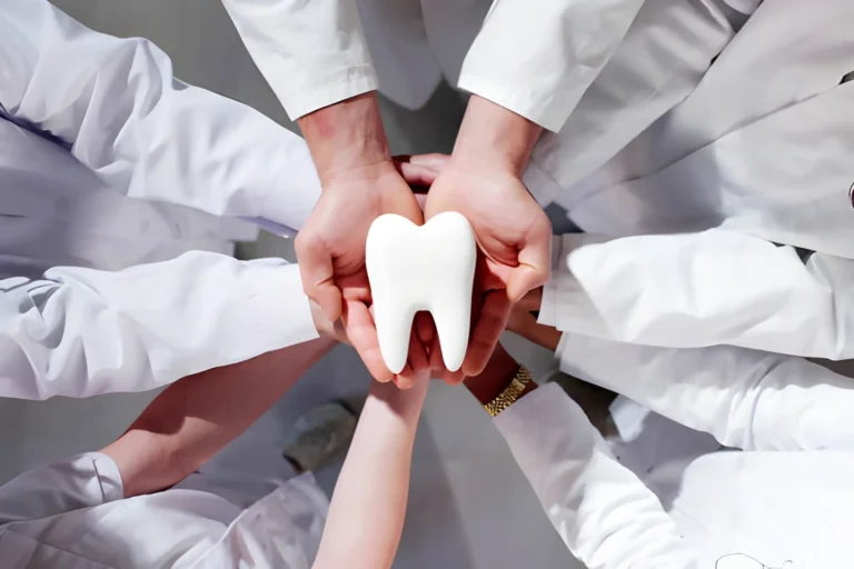 Smiling woman visiting dentist for routine cleaning covered by affordable dental insurance plan