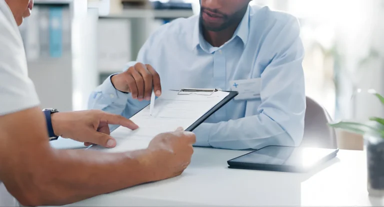 Family reviewing Health Insurance Iowa options with an agent in a local office setting